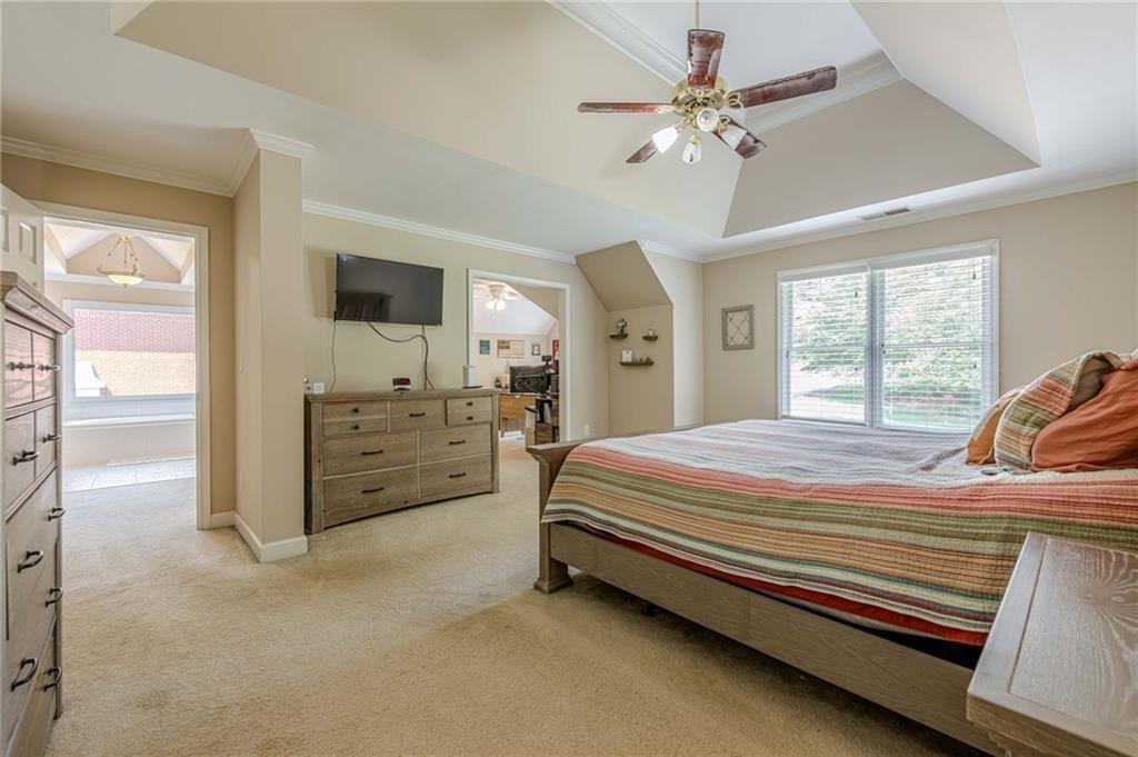 1765 Pinetree Pass Lane Southwest Lilburn, GA 30047 - Photo 19 of 44 a spacious bedroom with a bed and a chandelier