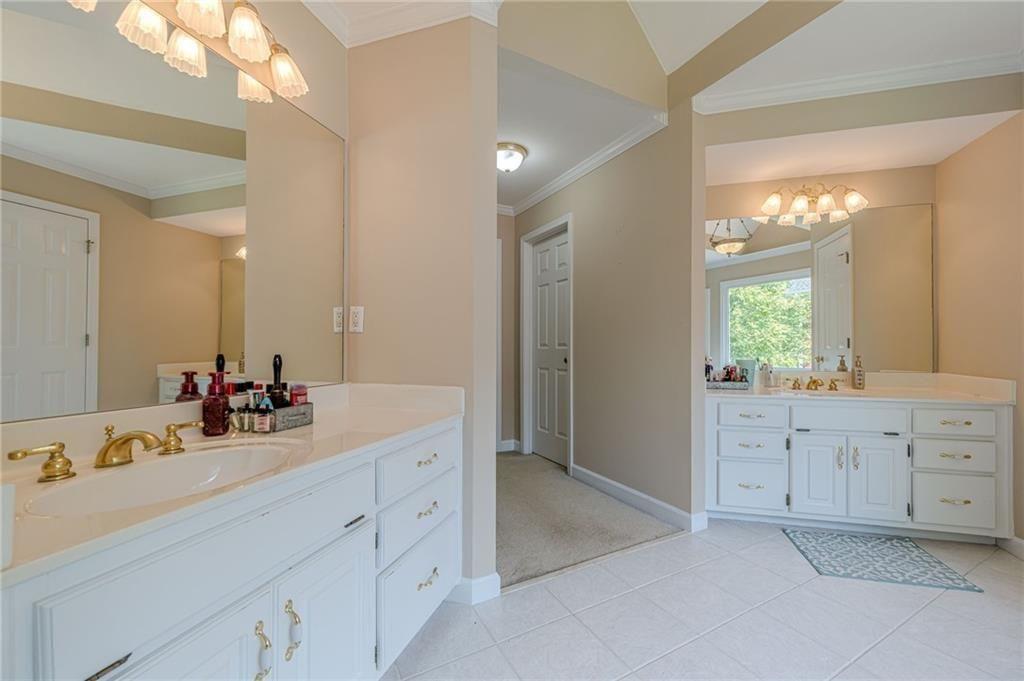 1765 Pinetree Pass Lane Southwest Lilburn, GA 30047 - Photo 24 of 44 a bathroom with a sink vanity and a mirror