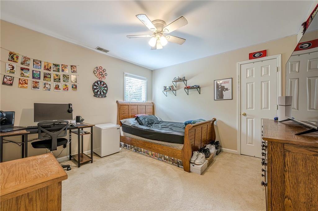 1765 Pinetree Pass Lane Southwest Lilburn, GA 30047 - Photo 33 of 44 a living room with furniture and a flat screen tv