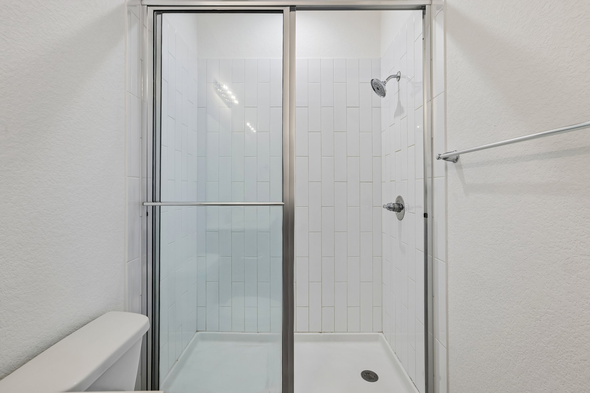 317 Independence Drive Kyle, TX 78640 - Photo 32 of 40 a bathroom with a glass shower door