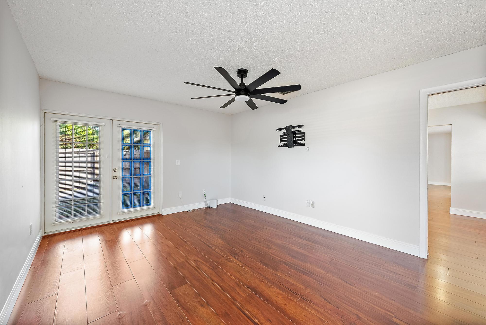 1199 Jackpine Street Wellington, FL 33414 - Photo 12 of 20 wooden floor in an empty room with a window