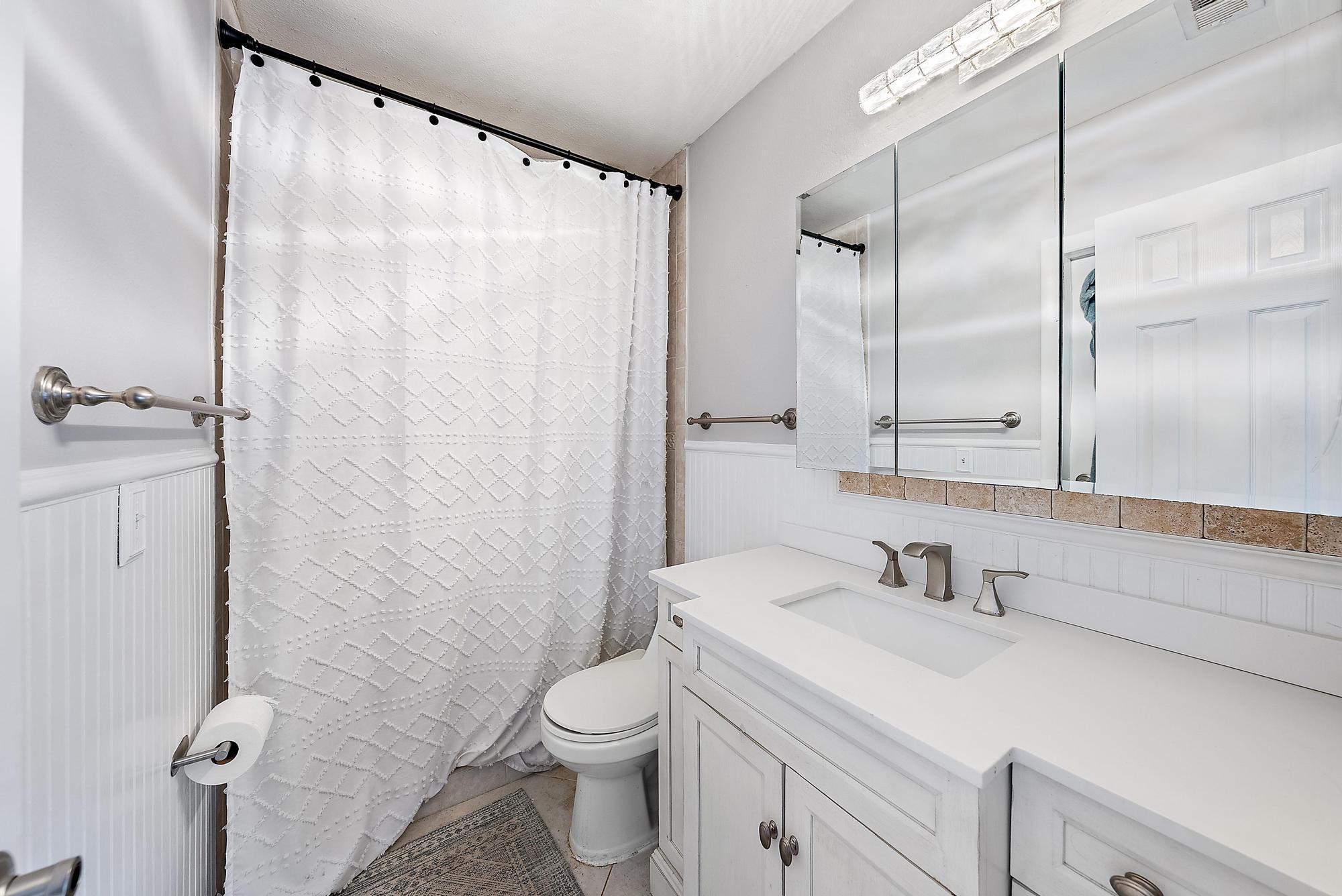 1199 Jackpine Street Wellington, FL 33414 - Photo 13 of 20 a bathroom with a sink a toilet and shower