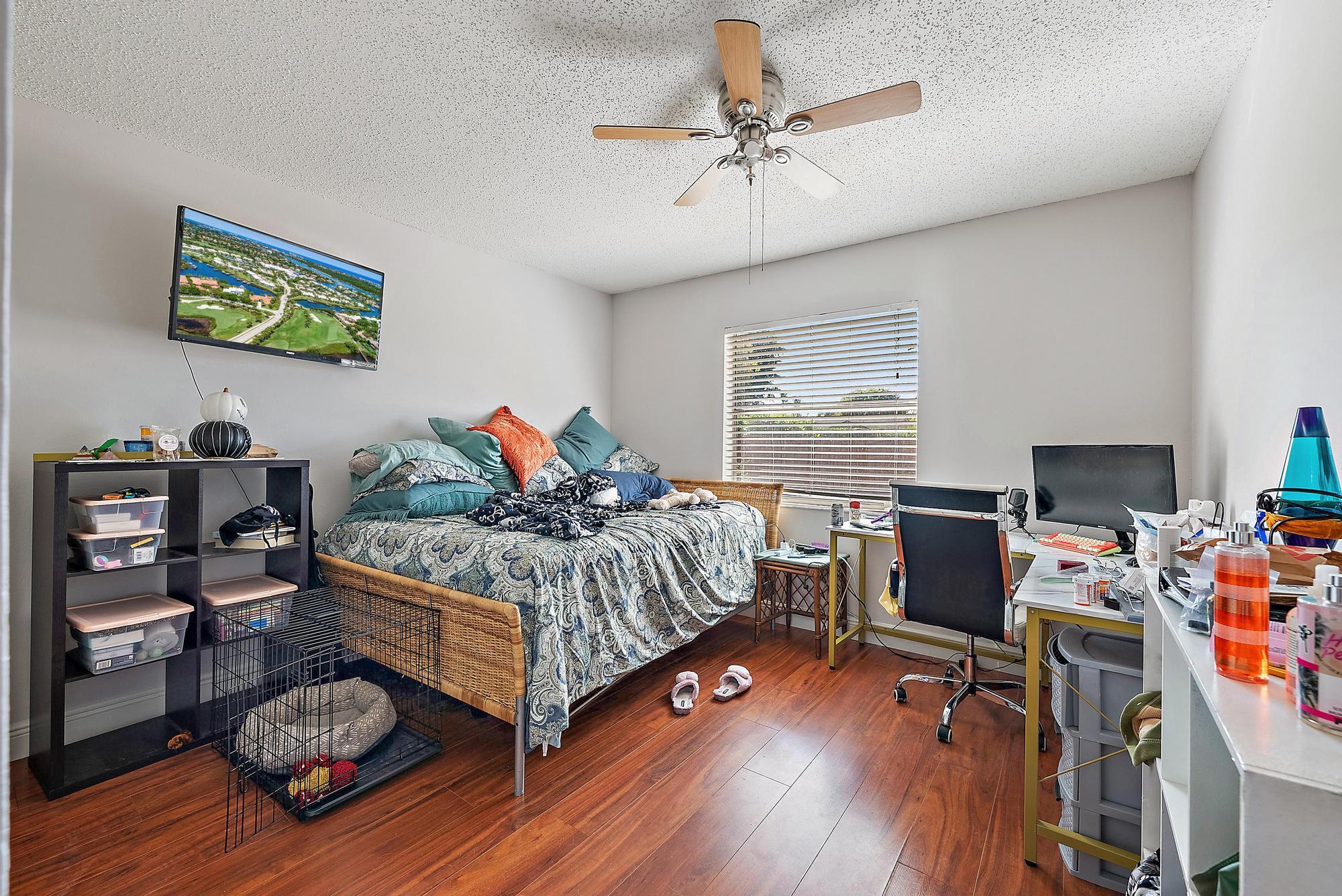 1199 Jackpine Street Wellington, FL 33414 - Photo 14 of 20 a bedroom with a bed and a wooden floor