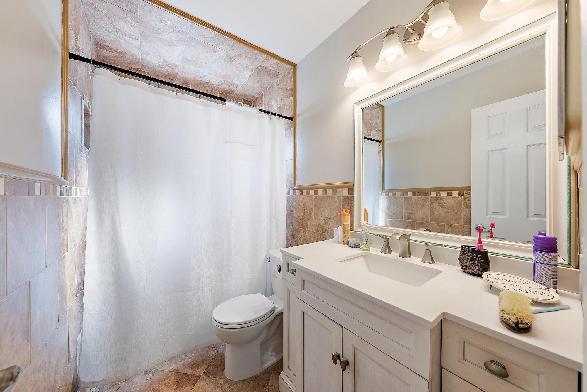 1199 Jackpine Street Wellington, FL 33414 - Photo 16 of 20 a bathroom with a sink and a mirror