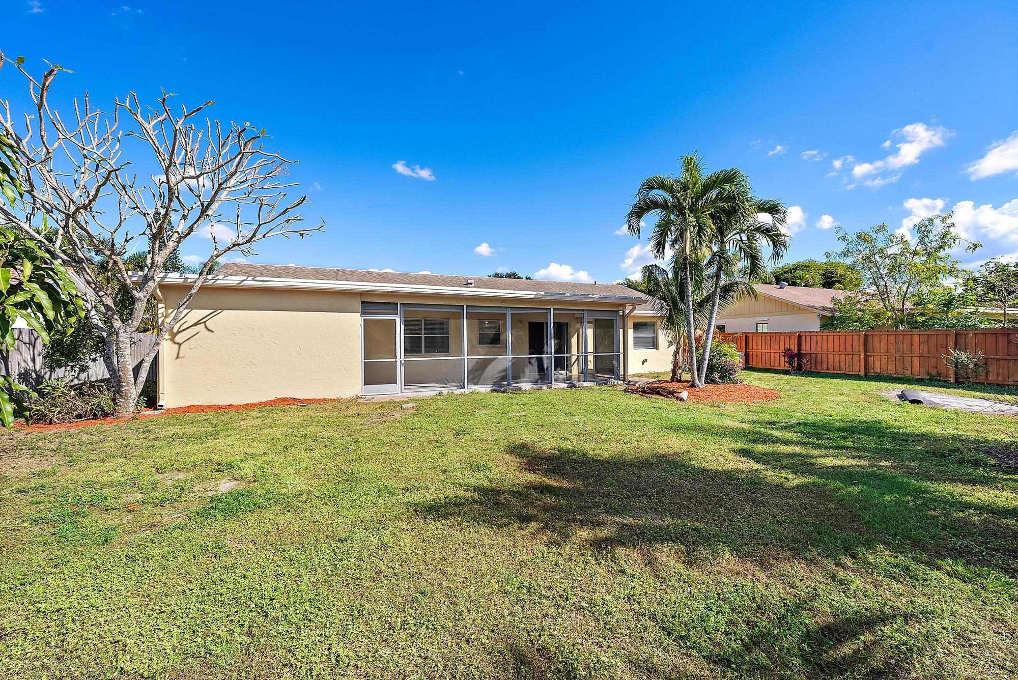 1199 Jackpine Street Wellington, FL 33414 - Photo 20 of 20 a front view of house with yard and green space