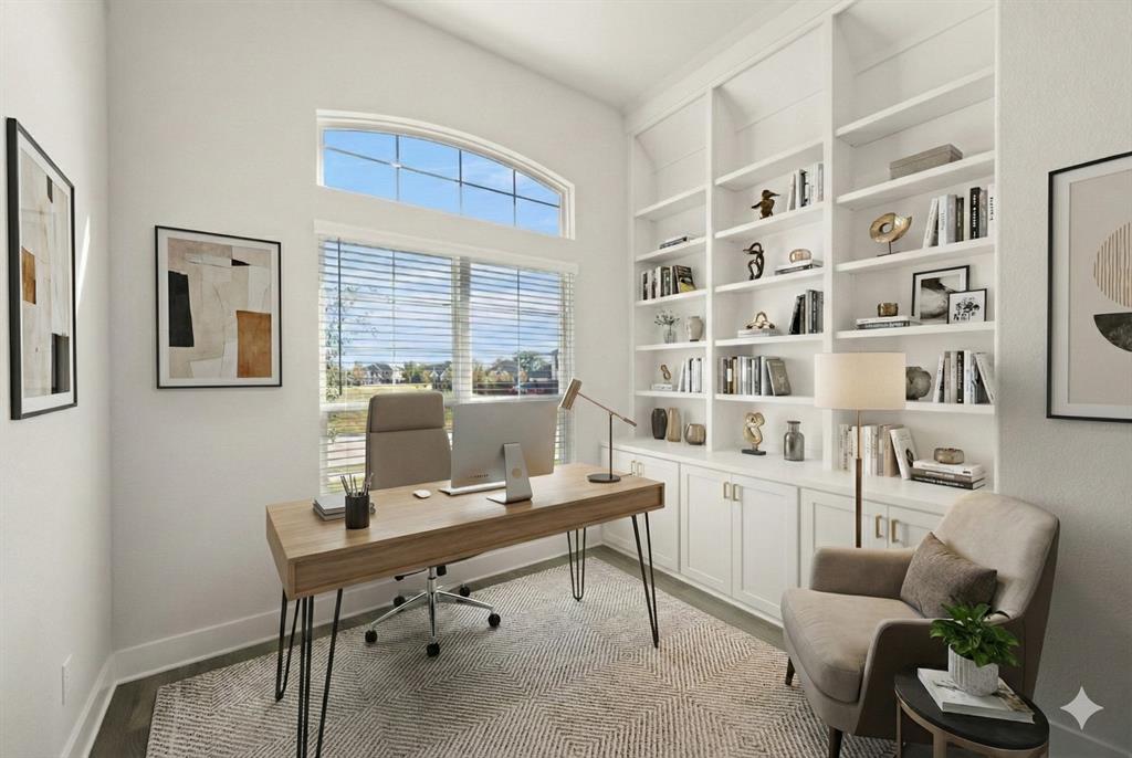 a view of a workspace with furniture and a window