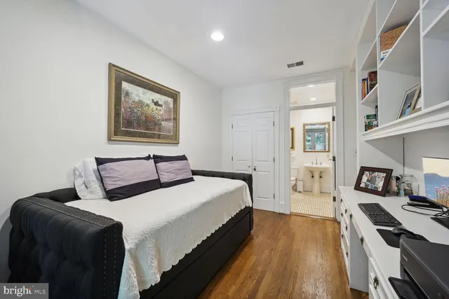a bedroom with bed and wooden floor