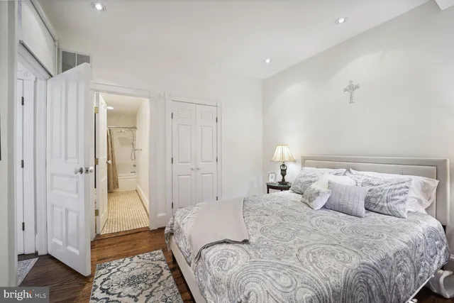 a spacious bedroom with a bed and a rug