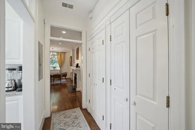 a view of a hallway with living room and couch