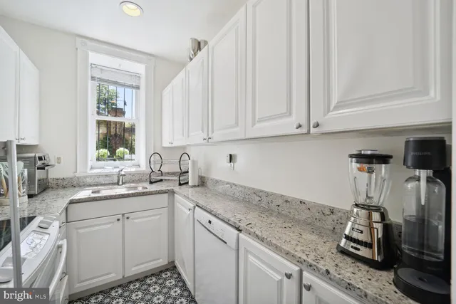 a kitchen with a sink stove and cabinets