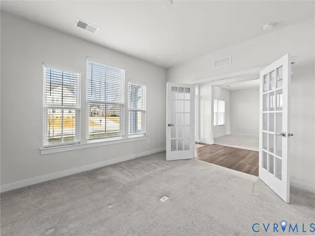 an empty room with windows and closet