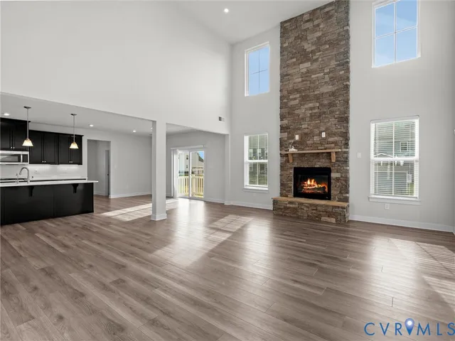 a view of a livingroom with a fireplace wooden floor and fire place