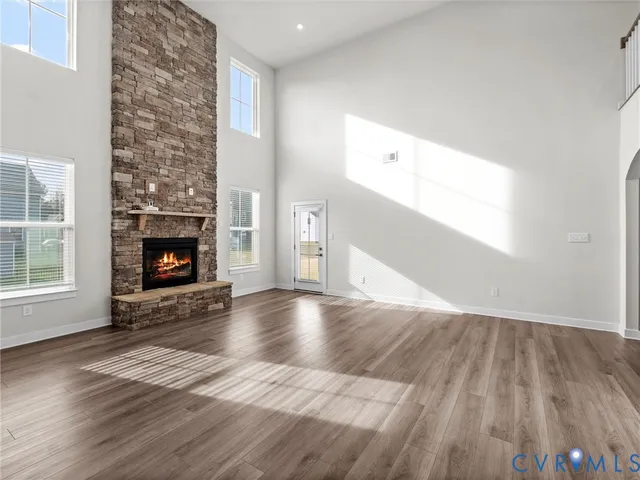 an empty room with wooden floor and fireplace