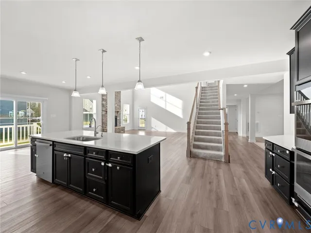 a kitchen with a sink and wooden floor