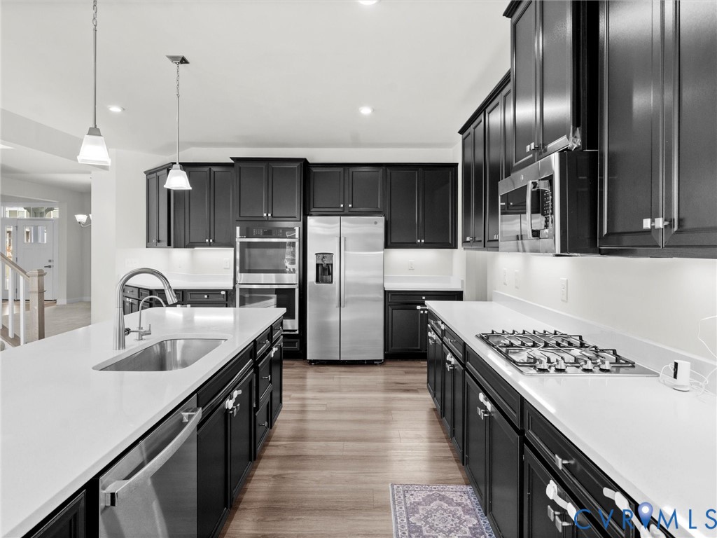 12029 Almer Lane Chester, VA 23836 - Photo 22 of 50 a kitchen with kitchen island stainless steel appliances a sink stove and refrigerator