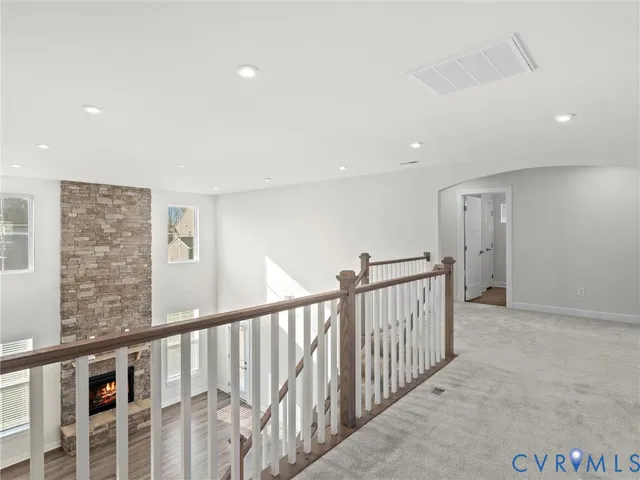 a spacious bedroom with a bed a couch and potted plant