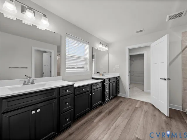 a kitchen with a sink and wooden floor