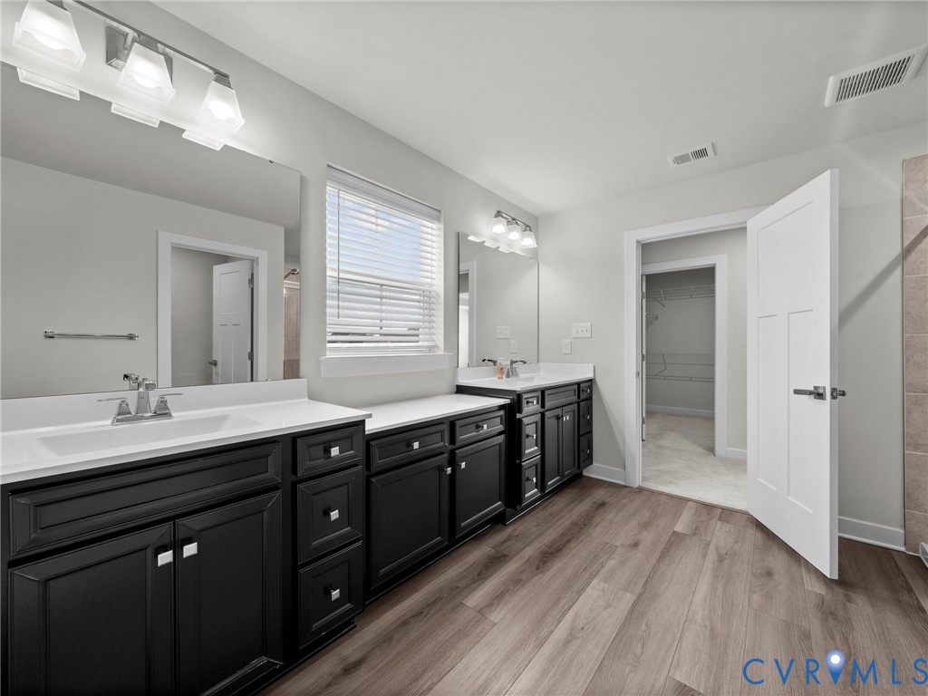 12029 Almer Lane Chester, VA 23836 - Photo 36 of 50 a large bathroom with double vanity and a large mirror