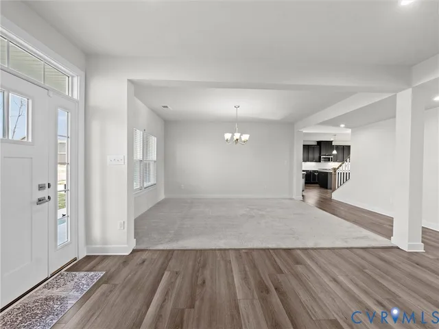 a view of kitchen and hall with wooden floor