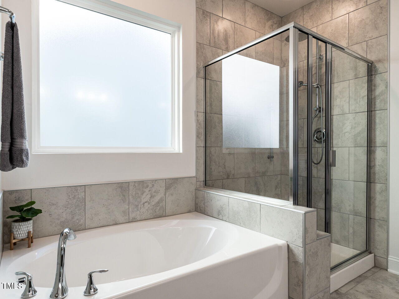 106 Ivory Lane Raleigh, NC 27610 - Photo 20 of 46 a bathroom with a bathtub and a shower