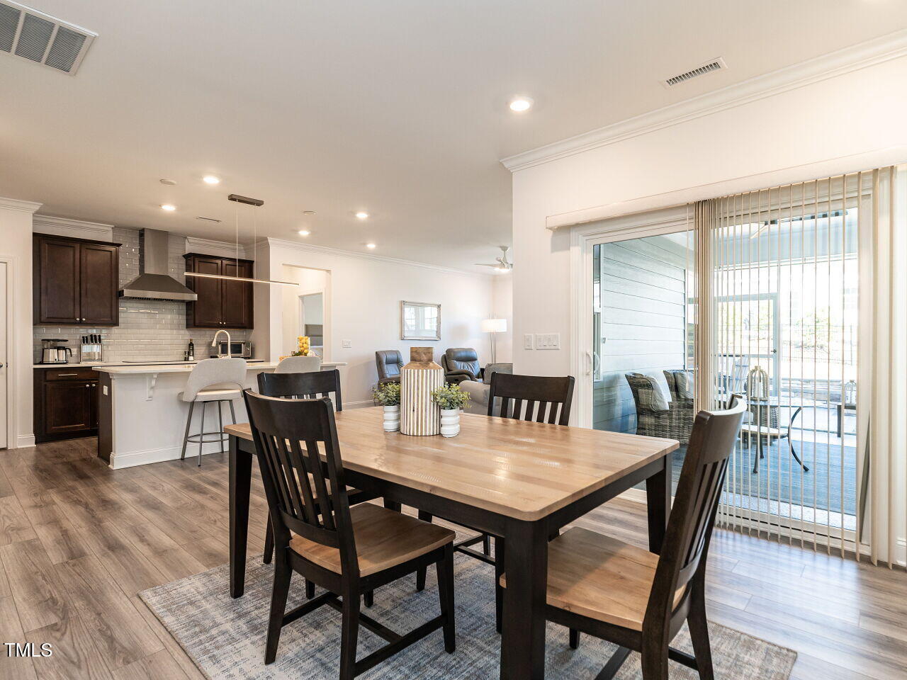106 Ivory Lane Raleigh, NC 27610 - Photo 6 of 46 a dining room with a table chairs and a kitchen view