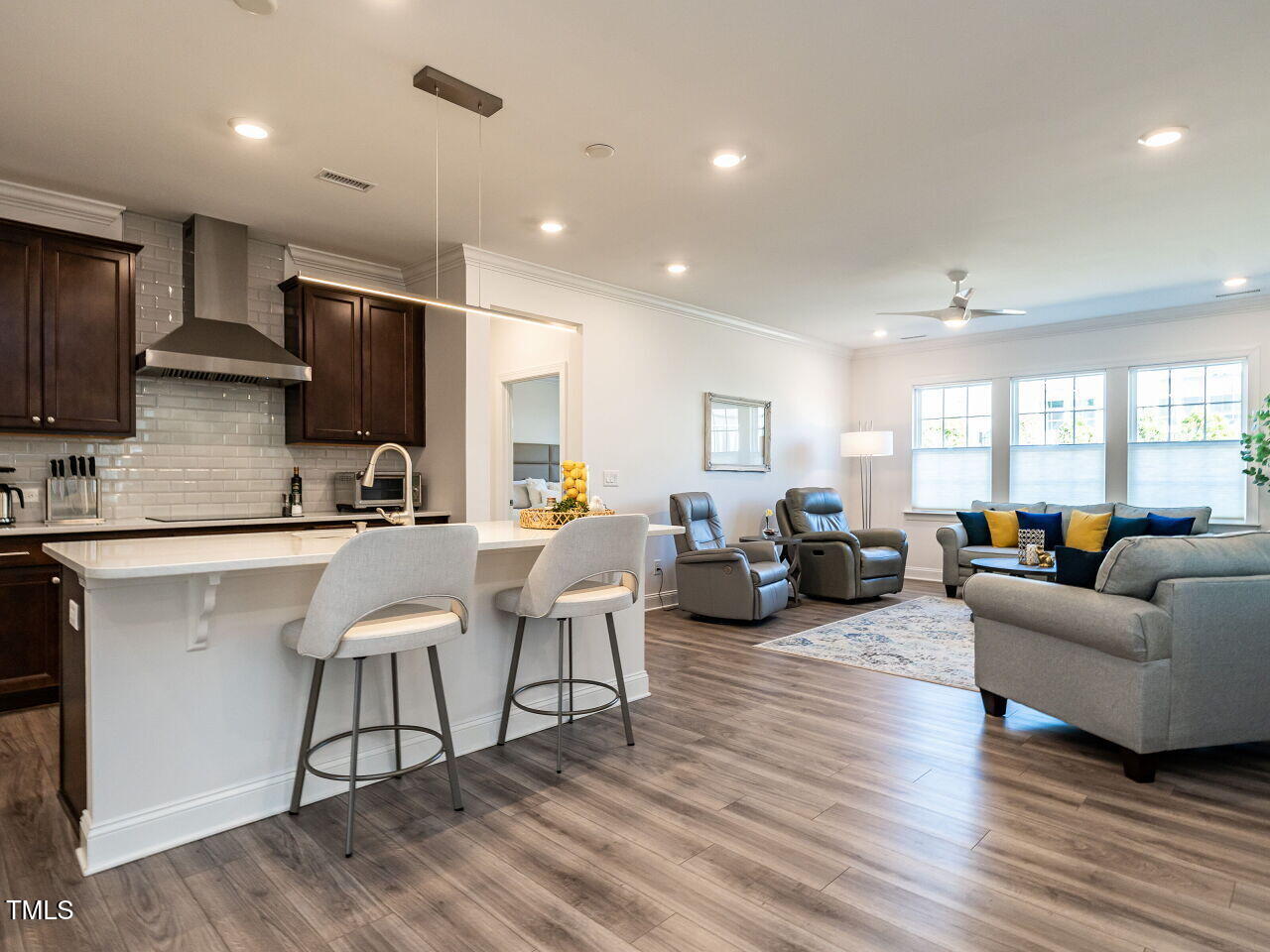 106 Ivory Lane Raleigh, NC 27610 - Photo 7 of 46 a living room kitchen with furniture and a wooden floor