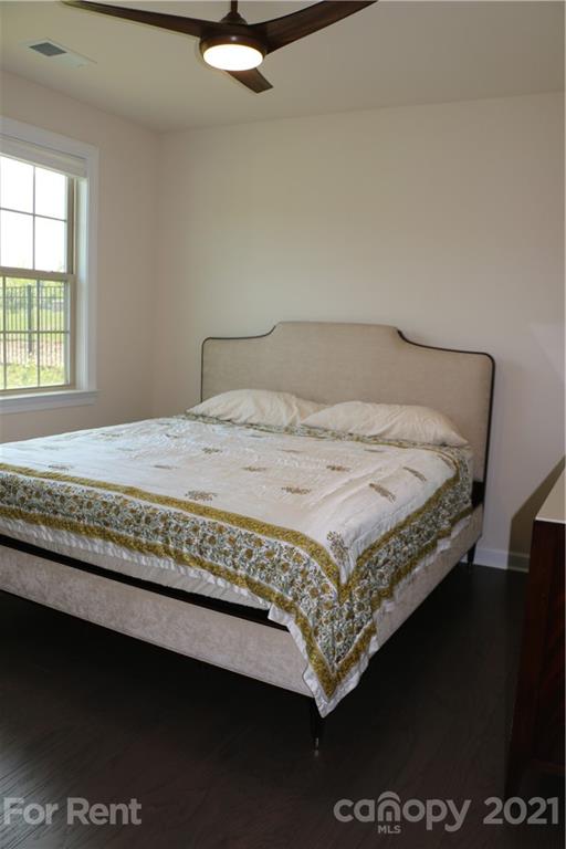 17540 Shearer Road Davidson, NC 28036 - Photo 15 of 27 a bed sitting in a bedroom next to a window