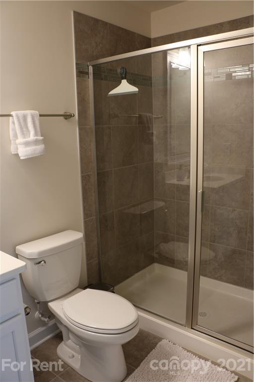 17540 Shearer Road Davidson, NC 28036 - Photo 16 of 27 a bathroom with a shower and a toilet