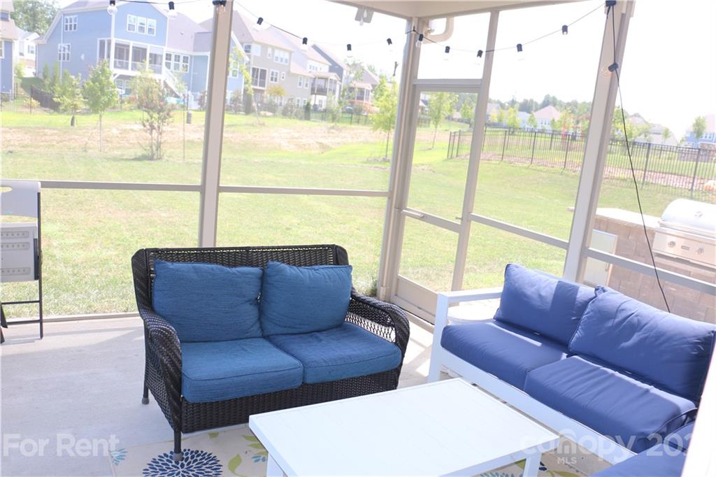 17540 Shearer Road Davidson, NC 28036 - Photo 23 of 27 a living room with furniture and a floor to ceiling window
