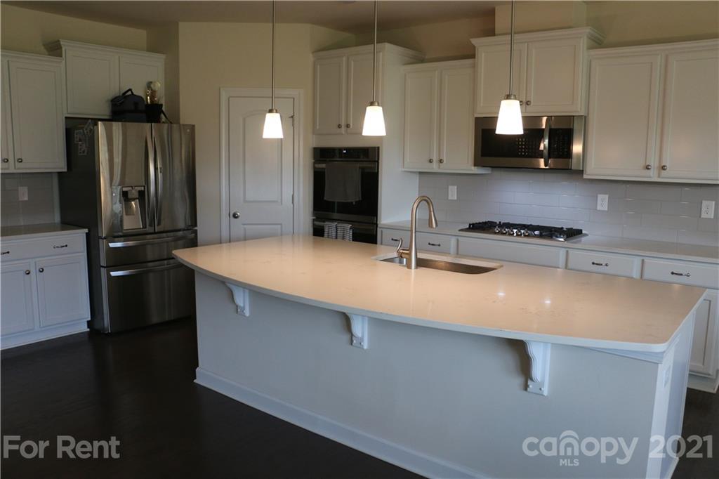 17540 Shearer Road Davidson, NC 28036 - Photo 4 of 27 a kitchen with stainless steel appliances a sink a stove and a refrigerator