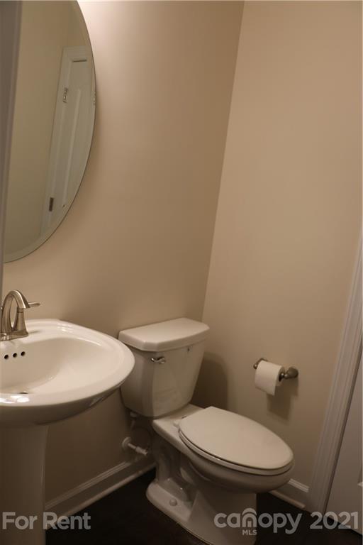 17540 Shearer Road Davidson, NC 28036 - Photo 10 of 27 a white toilet sitting next to a bathroom sink