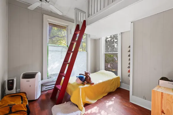 a bedroom with furniture and a window