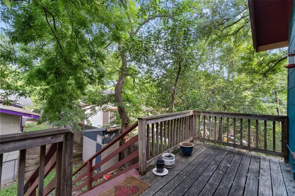 a view of balcony with wooden floor and fence