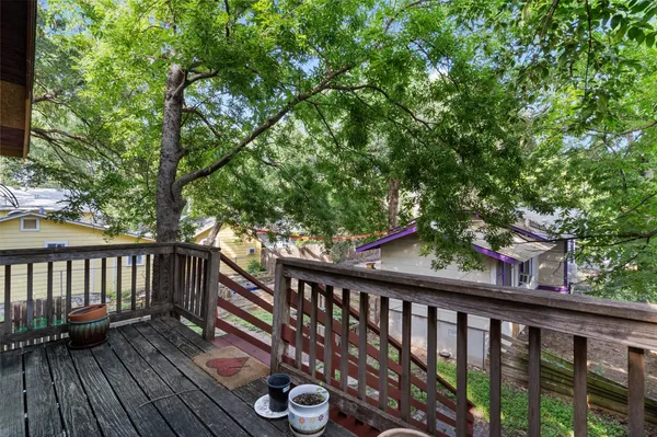 a view of balcony with wooden floor and fence