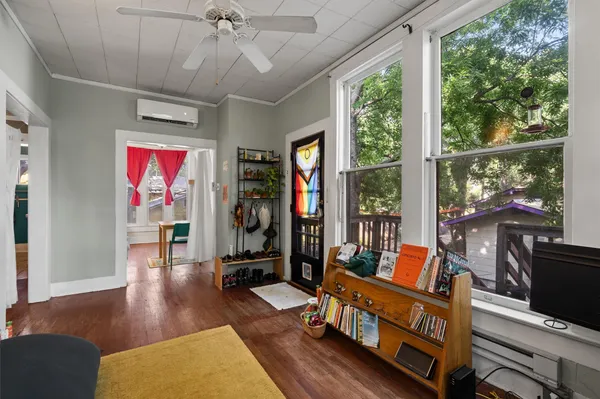 a living room with furniture a large window with wooden floor