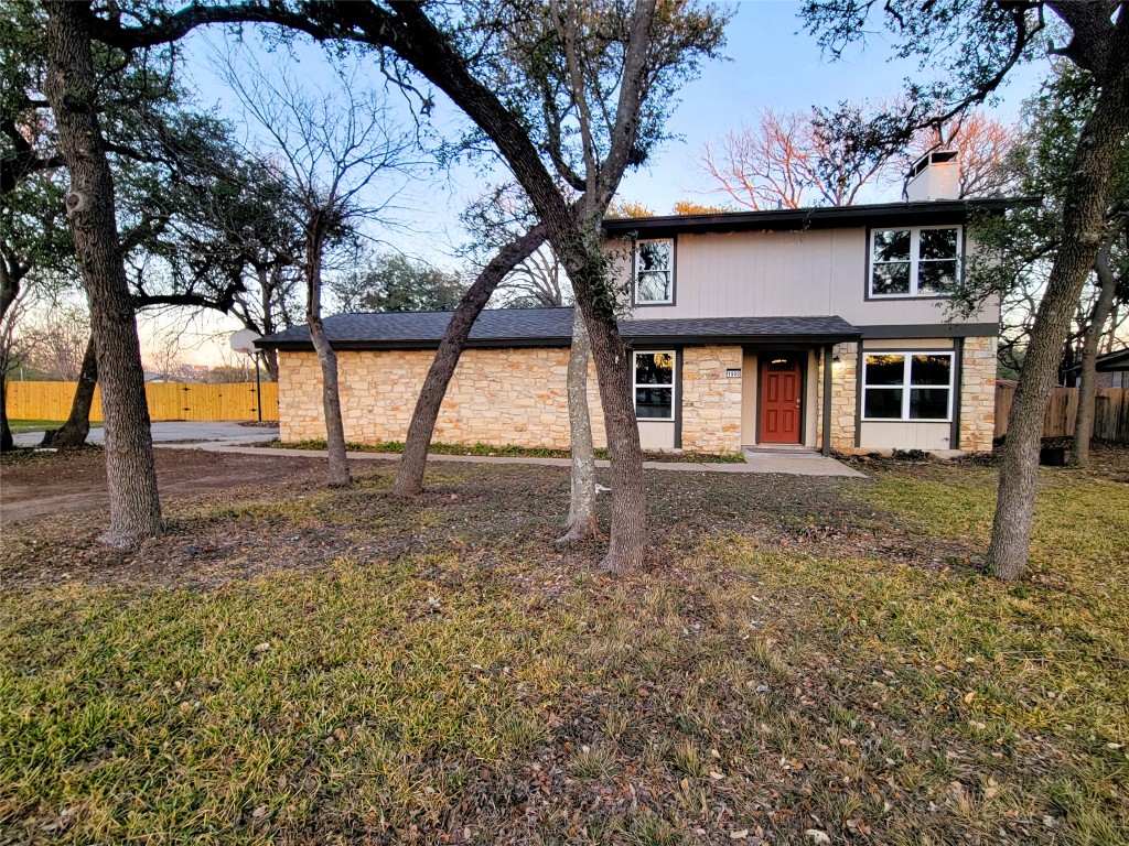 Texas ranch-style home with .45 acre lot, no HOA, white stone siding, new roof & fresh exterior paint
