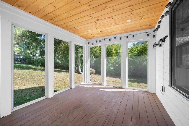 a porch with wooden floor and outdoor space