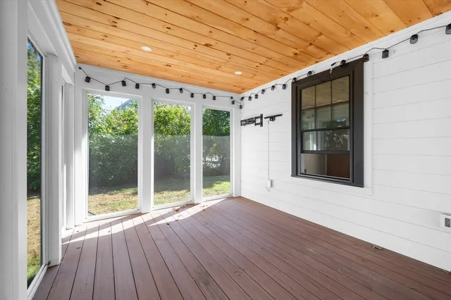 a view of a room with wooden floor and outdoor space