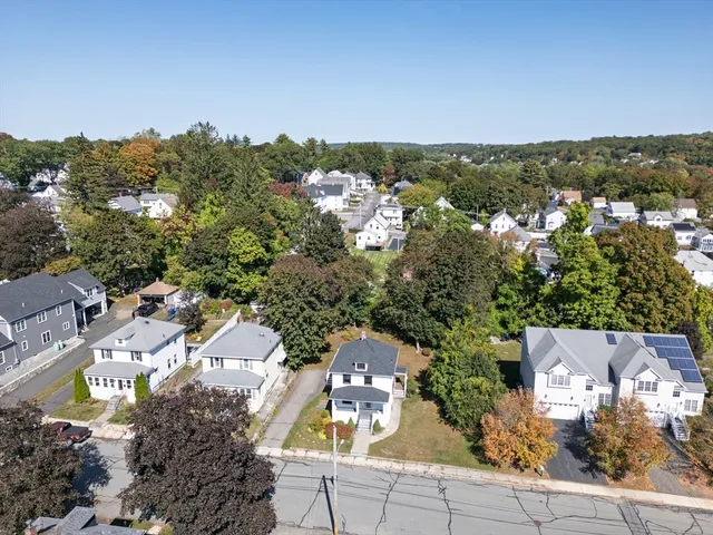 an aerial view of a house with a yard and garden