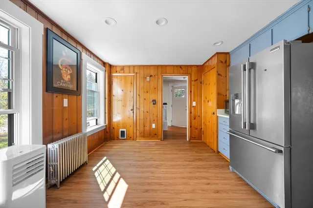 a large room with a large window and wooden floor