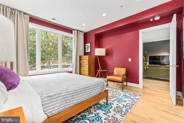 a bedroom with a bed and a large window