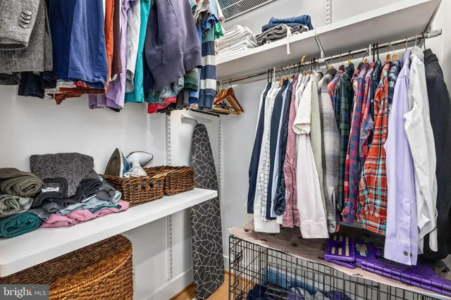 a view of walk in closet with clothes