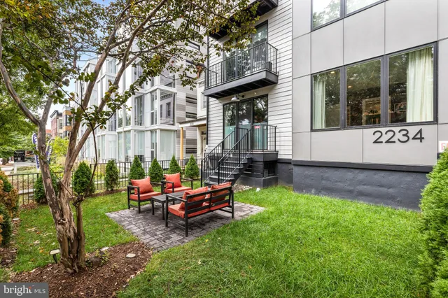 a backyard of a house with outdoor seating