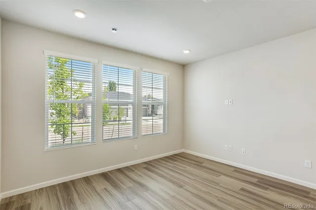 a open kitchen with a white stove top oven and white cabinets