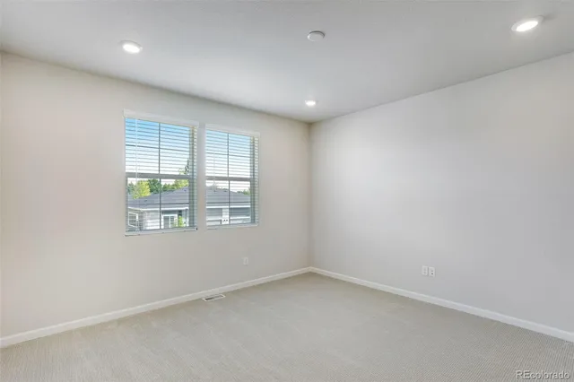 a bathroom with a granite countertop sink a large mirror and a shower
