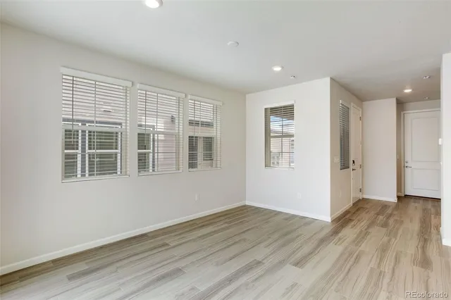 a large kitchen with stainless steel appliances kitchen island a large counter top and a wooden floors