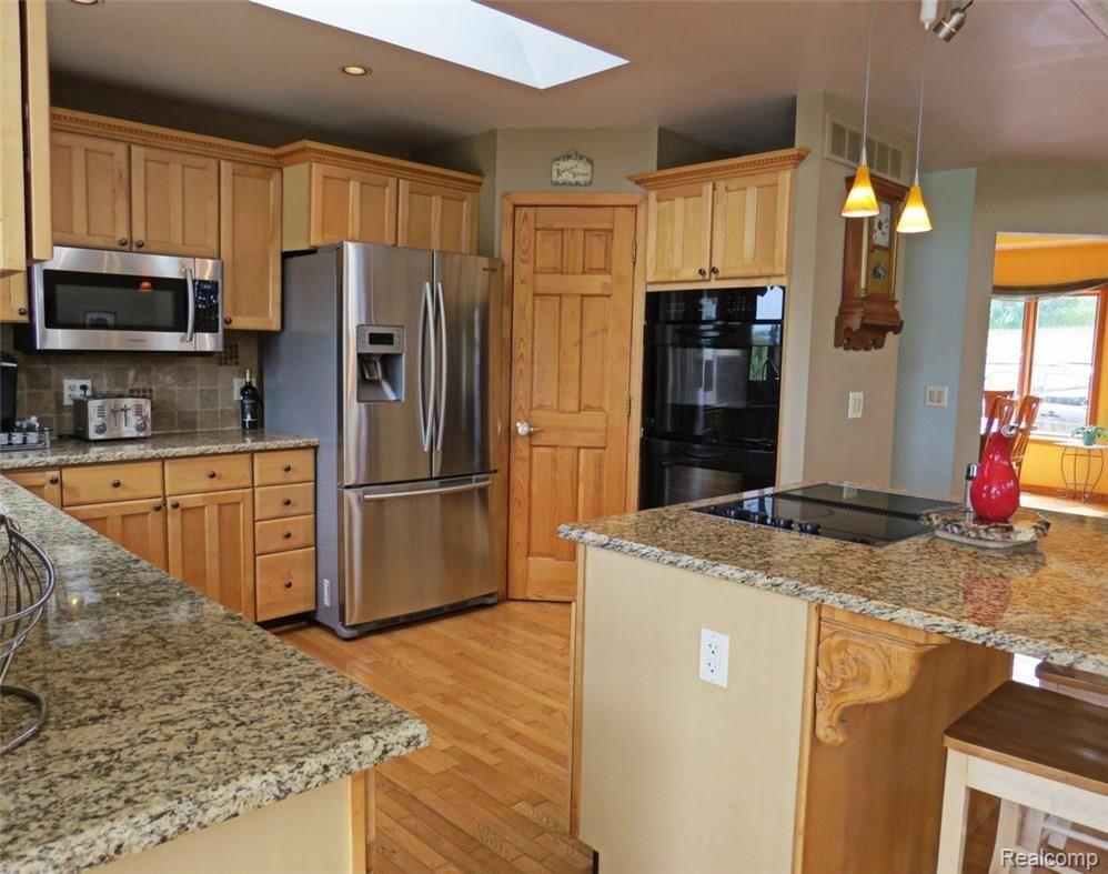 942 South Kern Road Fowlerville, MI 48836 - Photo 16 of 77 Notice the skylight for natural lighting and pantry cabinet