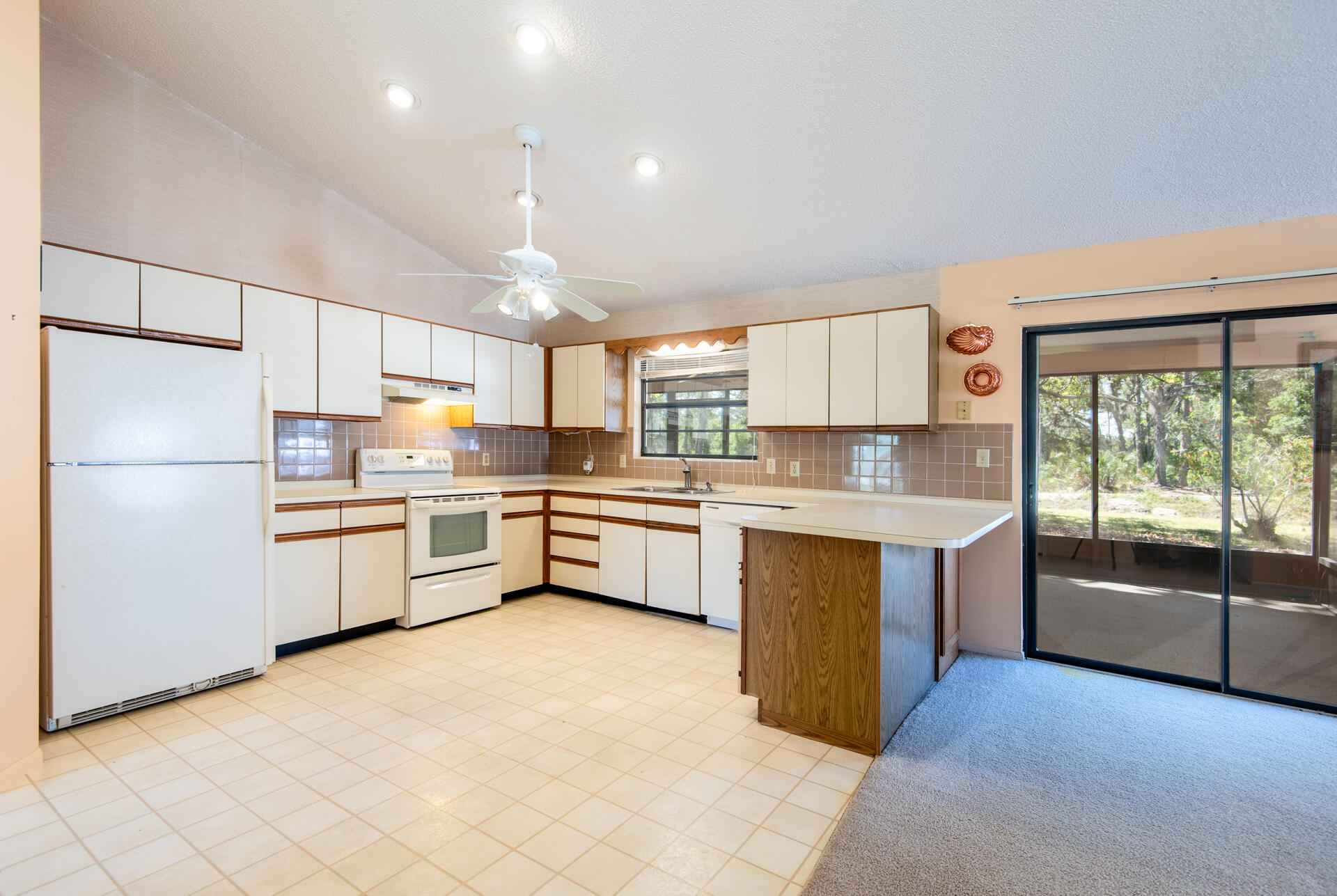 248 Rheine Road Northwest Palm Bay, FL 32907 - Photo 8 of 22 a kitchen with stainless steel appliances a refrigerator sink and microwave