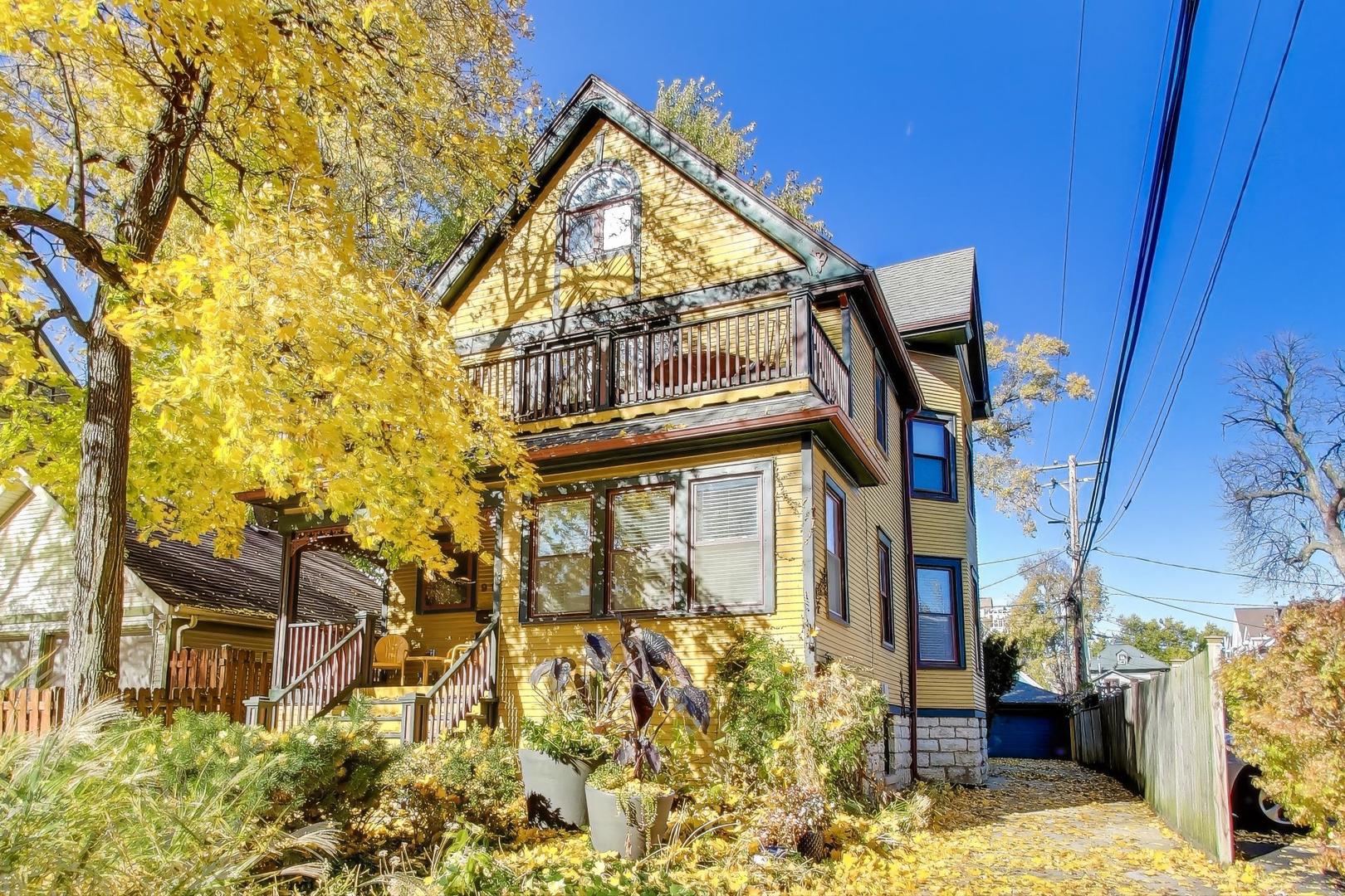 a view of a house with wooden fence