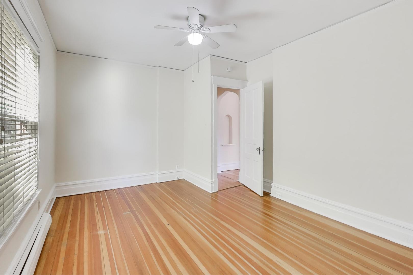 916 Pleasant Street, Unit 1 Oak Park, IL 60302 - Photo 13 of 23 wooden floor in an empty room with a window